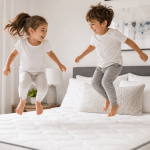 Happy kids jumping on a clean mattress