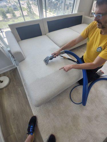 Nik is showing the difference before and after our professional upholstery cleaning in downtown Toronto